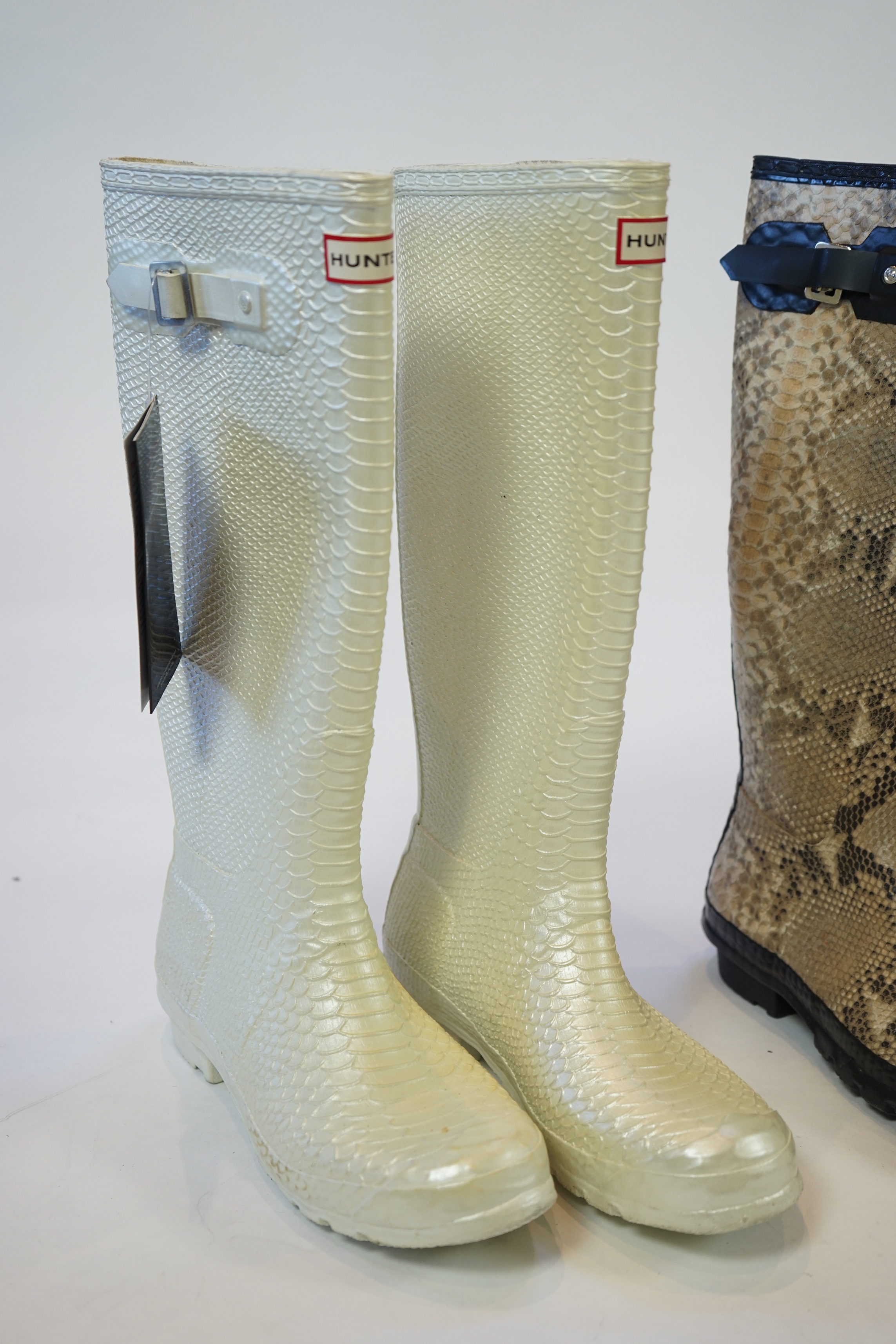 Two pairs of lady's Hunter snake-skin effect wellington boots, size UK 7